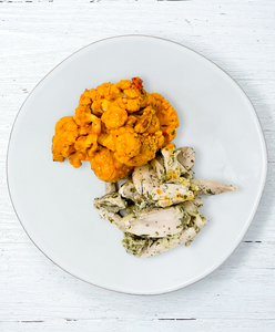 A plate of Ranch Chicken With Buffalo Cauliflower